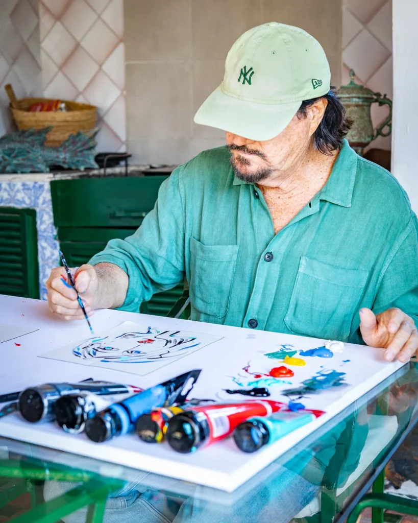 Ginés Serrán Pagán pintando con un pincel un retrato de una mujer en su casa